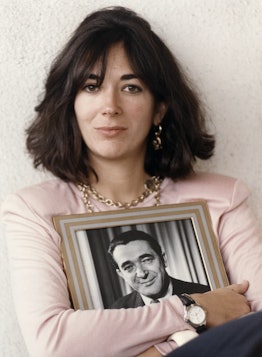 Ghislaine Maxwell holding a framed photograph of her father Robert Maxwell.
