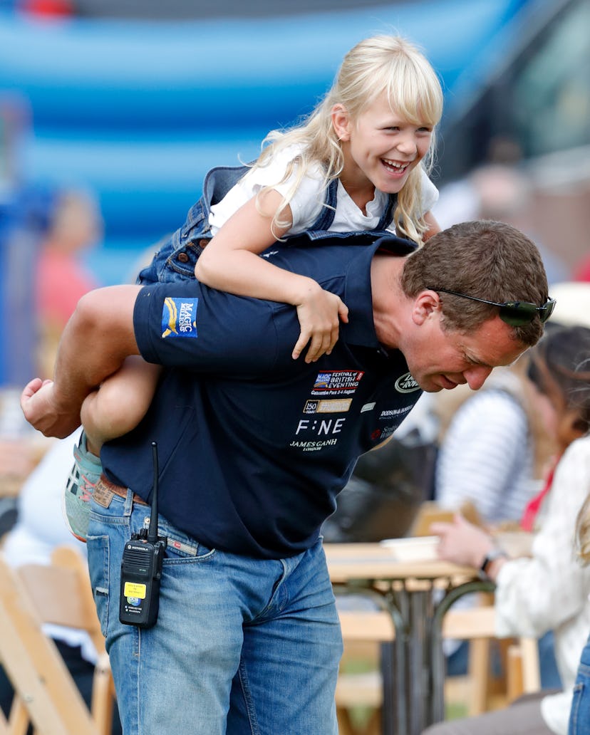 Isla Phillips gets a piggyback ride from her dad Peter Phillips.