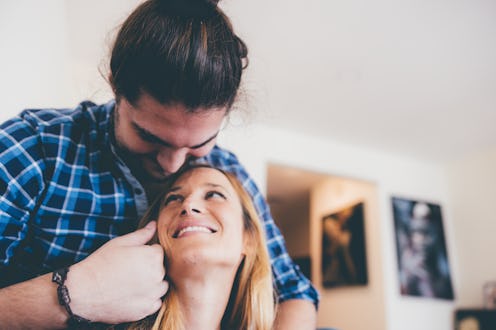Diverse couple seated comfortably at their living room