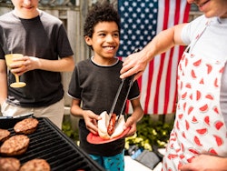 kid waiting for burgers at july 4th bbq; how to explain fourth of july to your kids