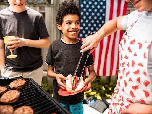 kid waiting for burgers at july 4th bbq; how to explain fourth of july to your kids