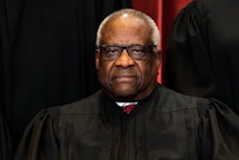 Associate Justice Clarence Thomas sits during a group photo of the Justices at the Supreme Court in ...