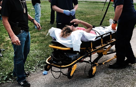 WARREN, OH - JULY 14: Medical workers and police treat a woman who has overdosed on heroin, the seco...