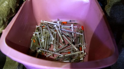 Bucket with used syringes is found at the open air heroin camp located, in the Kensington Section of...