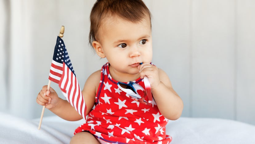 pair a photo of a cute baby holding united states flag with a festive fourth of july instagram capti...
