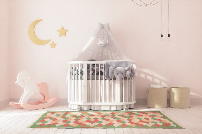 Empty crib in a decorated nursery at home.