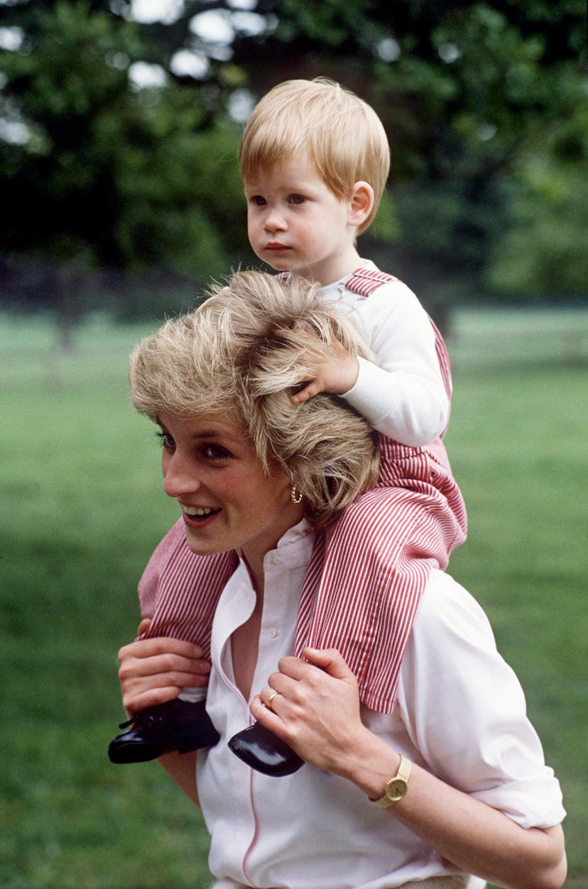 Princess Diana carries Prince Harry on her shoulders. 