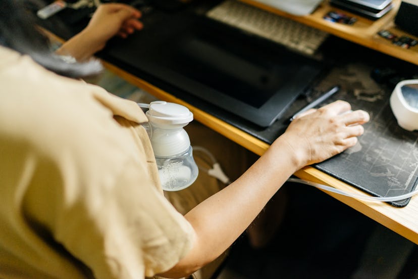 woman wearing a breast pump while working at computer