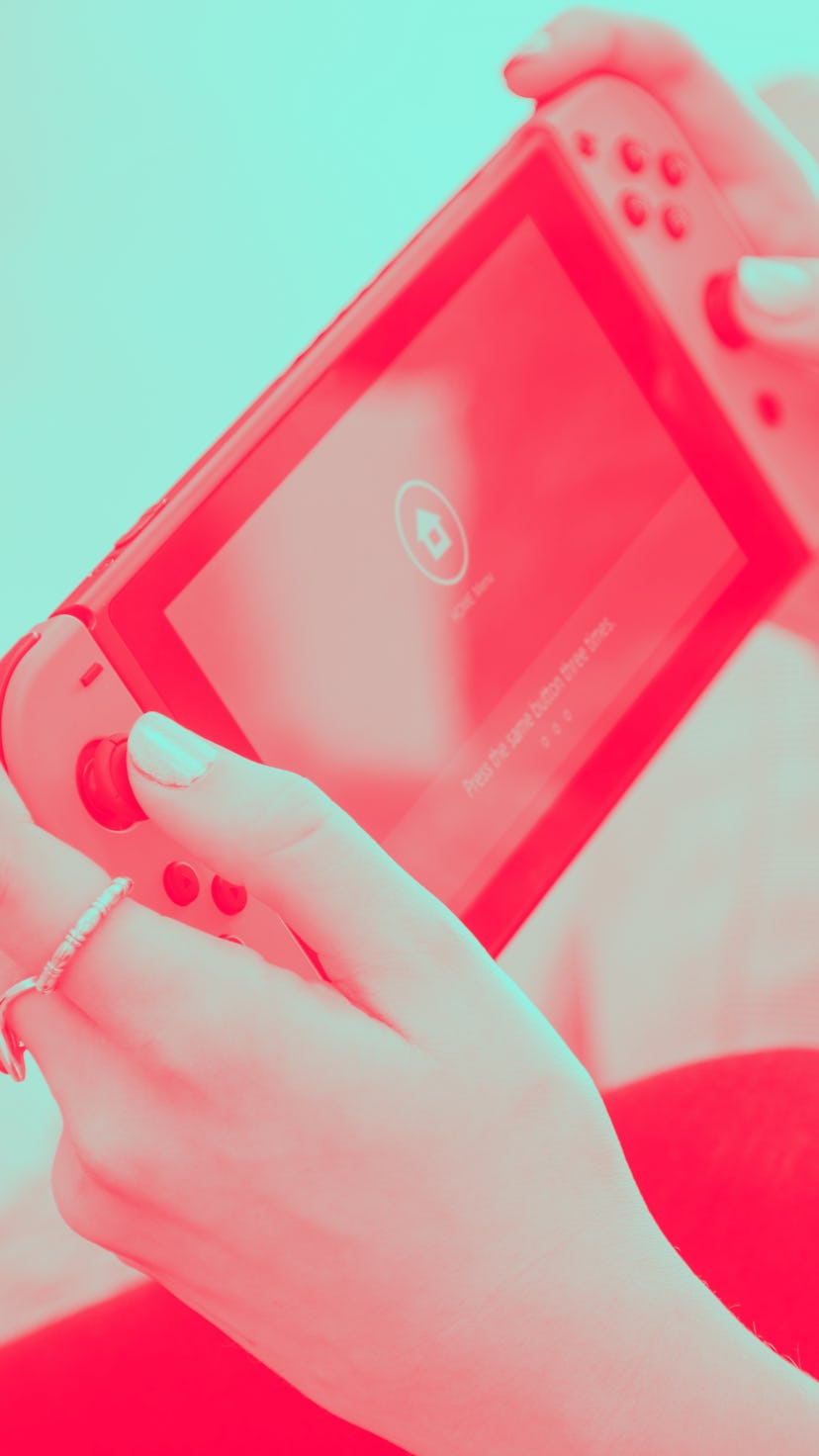 Detail of a young woman playing video games on a Nintendo Switch home console, taken on March 7, 201...