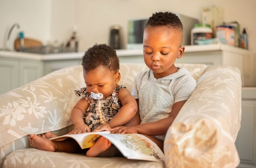 kid brother reading to younger baby sister in roundup of unique nicknames for boys sons