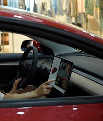 HUAI'AN, CHINA - JUNE 13, 2021 - Residents view a new energy Tesla car at a shopping mall in Huai 'a...