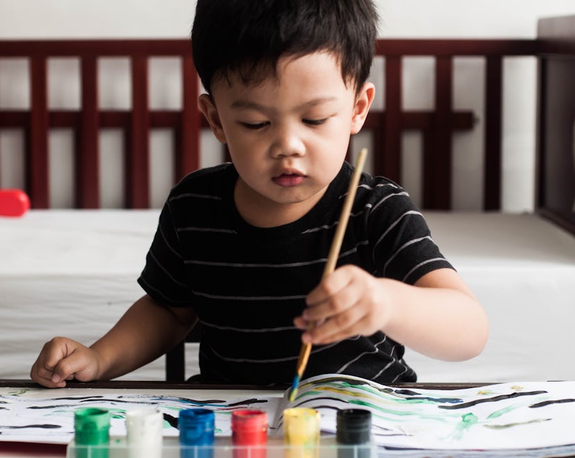 young toddler boy painting at home in roundup of cute and unique nicknames for boys/sons