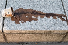 PORTLAND, OR - JUNE 27: An abandoned and melting pint of ice cream drys along a city street on June ...