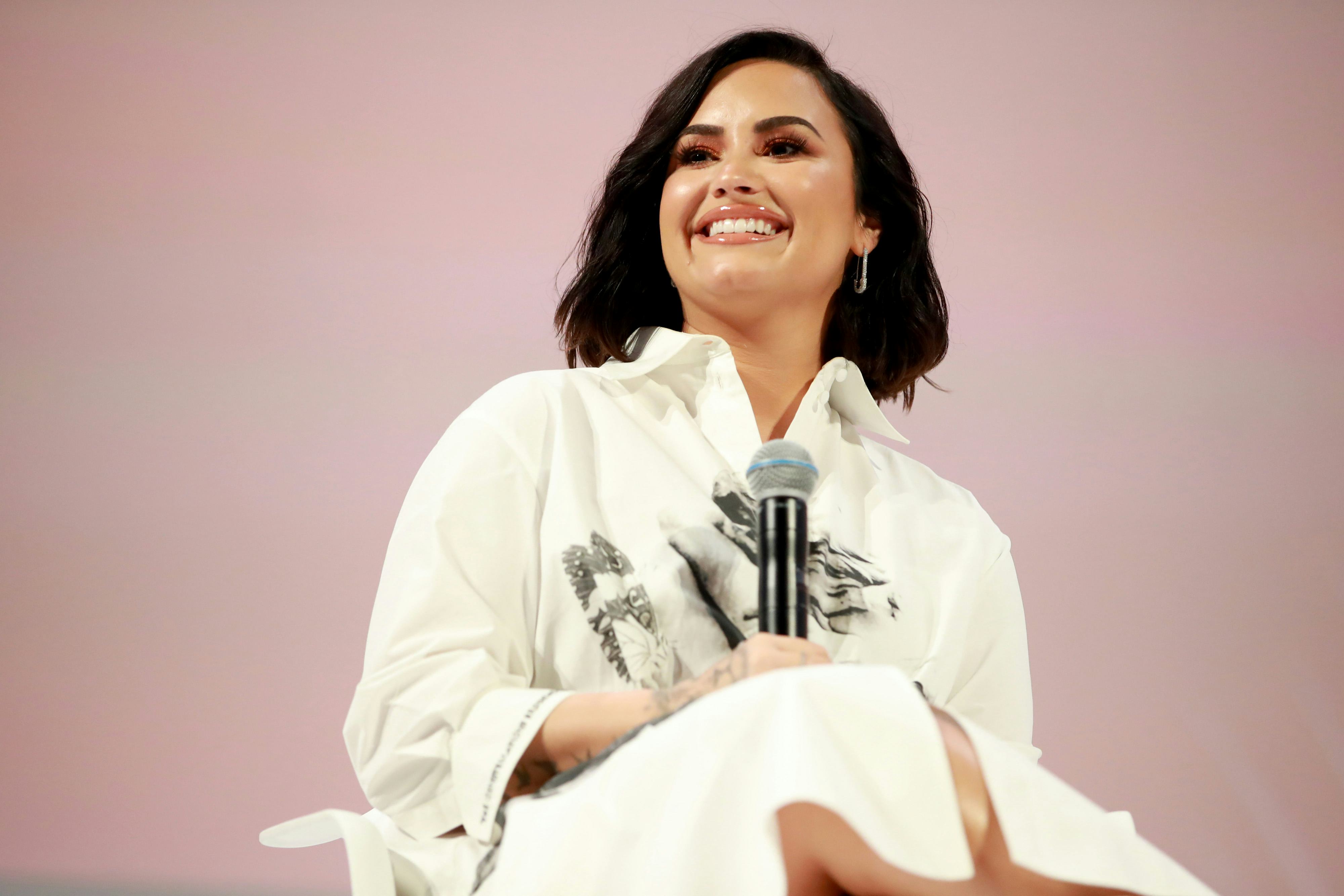 Demi Lovato in a white shirt smiles and speaks at the Teen Vogue Summit 2019 at Goya Studios in Los ...