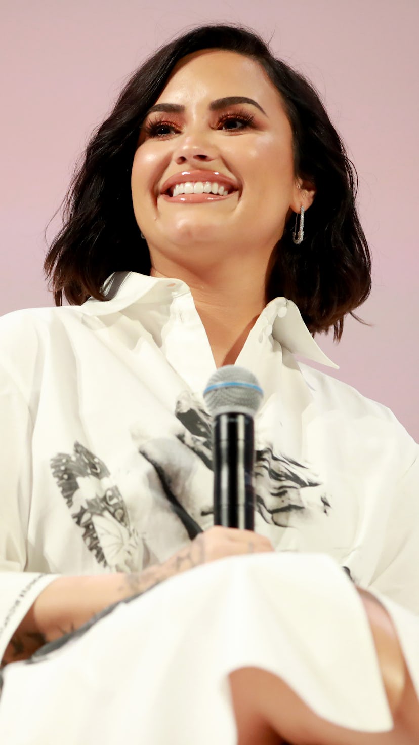 Demi Lovato in a white shirt smiles and speaks at the Teen Vogue Summit 2019 at Goya Studios in Los ...