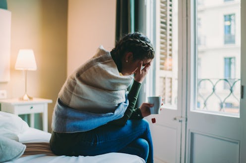 A woman holds her head after a night drinking alcohol. Wondering why can't i drink alcohol anymore w...