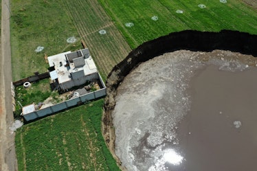 Aerial view of a sinkhole that was found by farmers in a field of crops in Santa Maria Zacatepec, st...