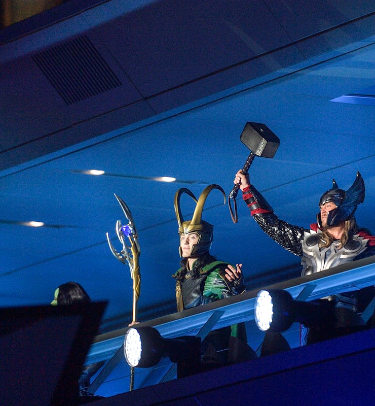 Loki, Thor, and Iron Man stand at Avenger Headquarters during the opening ceremony for Avengers Camp...