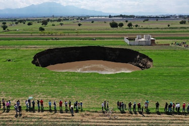 TOPSHOT - Aerial view of a sinkhole that was found by farmers in a field of crops in Santa Maria Zac...