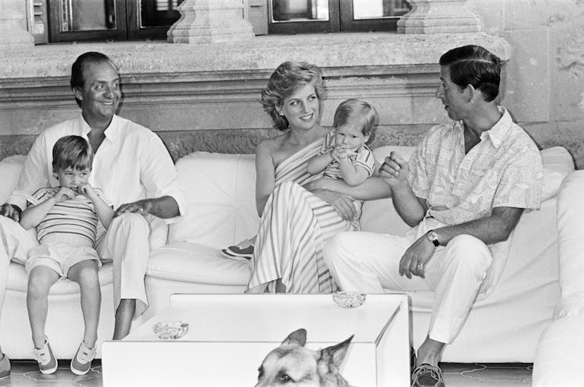 Prince William sits on King Juan Carlos' lap.