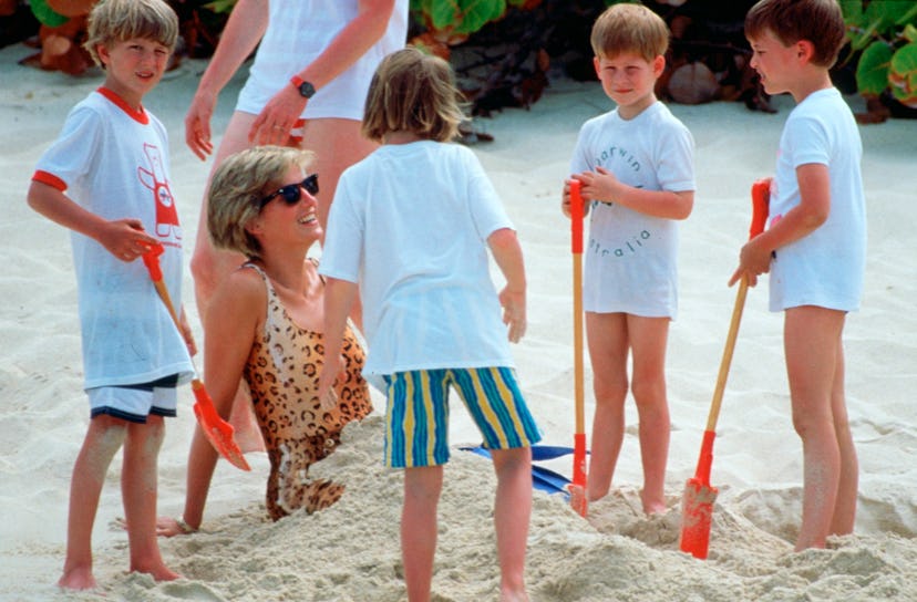 Princess Diana gets buried in the sand by her sons.