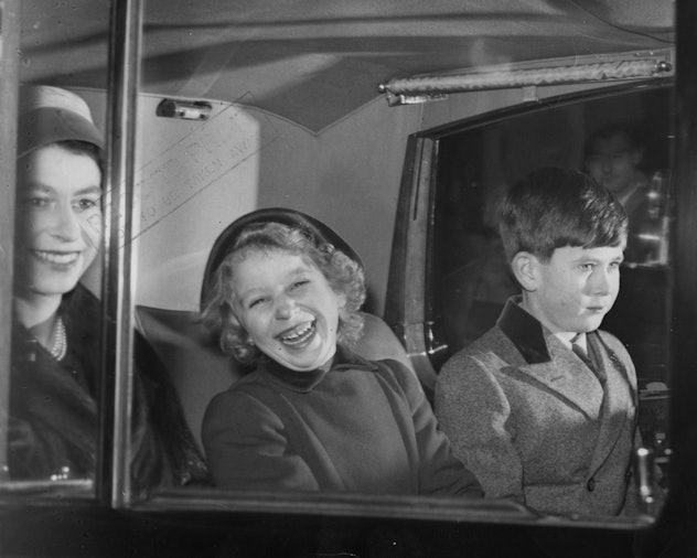 Princess Anne as a young girl laughing in a car.