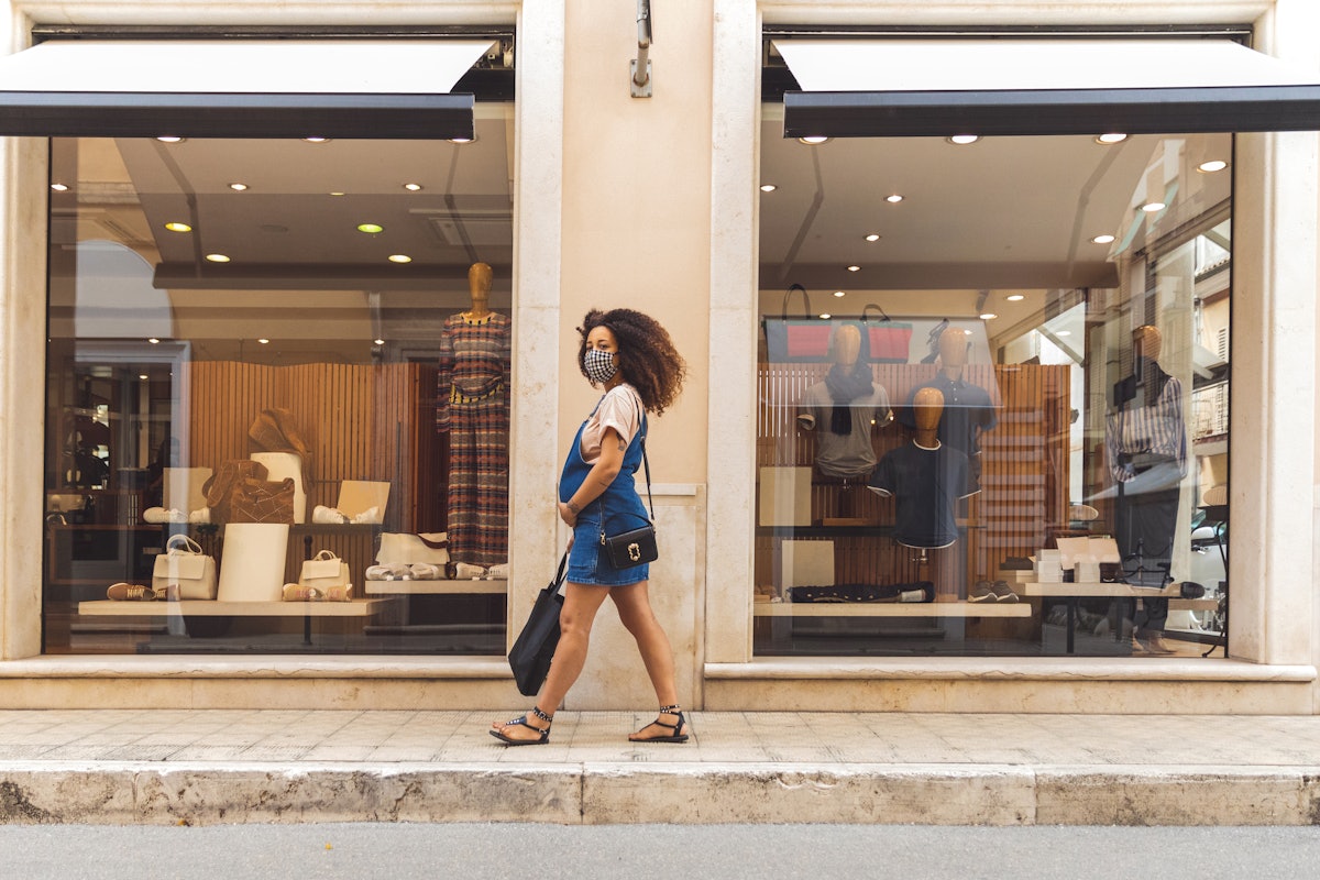 A woman walks down the street while doing a walking meditation.