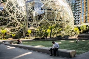 SEATTLE, WA - MAY 20: People use a common space outside of The Spheres at the Amazon.com Inc. headqu...