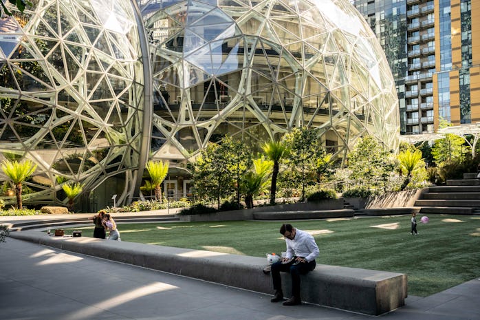 SEATTLE, WA - MAY 20: People use a common space outside of The Spheres at the Amazon.com Inc. headqu...
