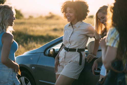 Group of happy young people laughing and having fun while meeting on the road