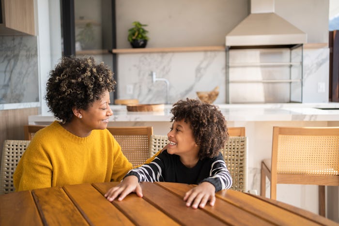 Portrait of happy family, mother and son smiling at home.