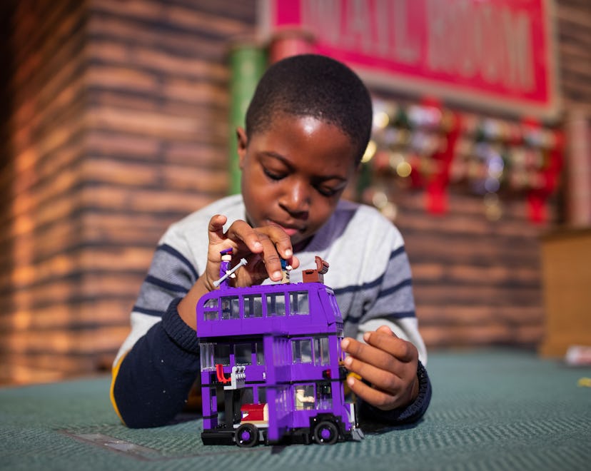 Peter Olunloyo, 8, plays with a Harry Potter Knight bus toy by LEGO, which was named in the top 12 t...