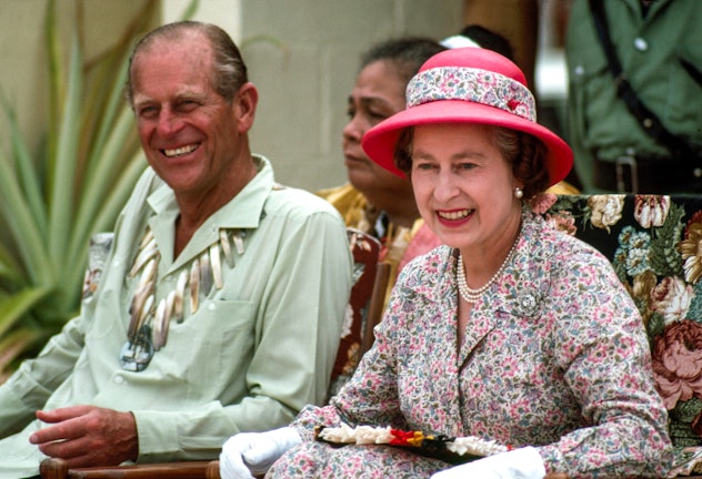 Queen Elizabeth and Prince Philip laugh together in Tuvalu In The South Pacific. 