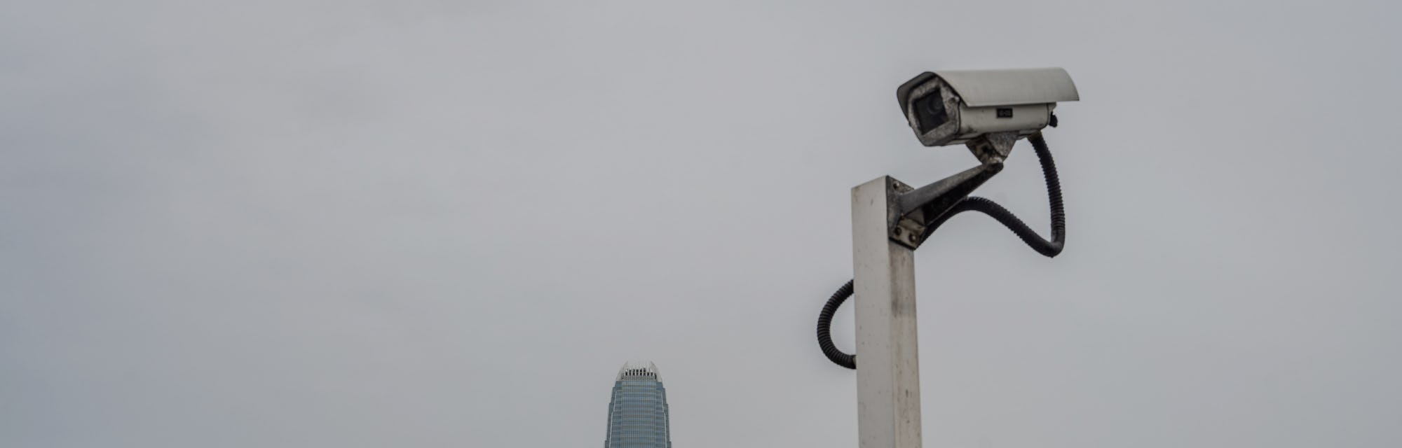 HONG KONG, CHINA - 2021/06/22: The CCTV camera monitor is set in front of the city skyline at the Vi...