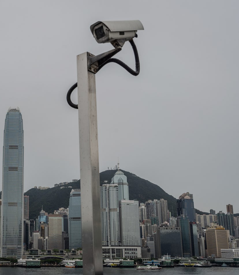 HONG KONG, CHINA - 2021/06/22: The CCTV camera monitor is set in front of the city skyline at the Vi...