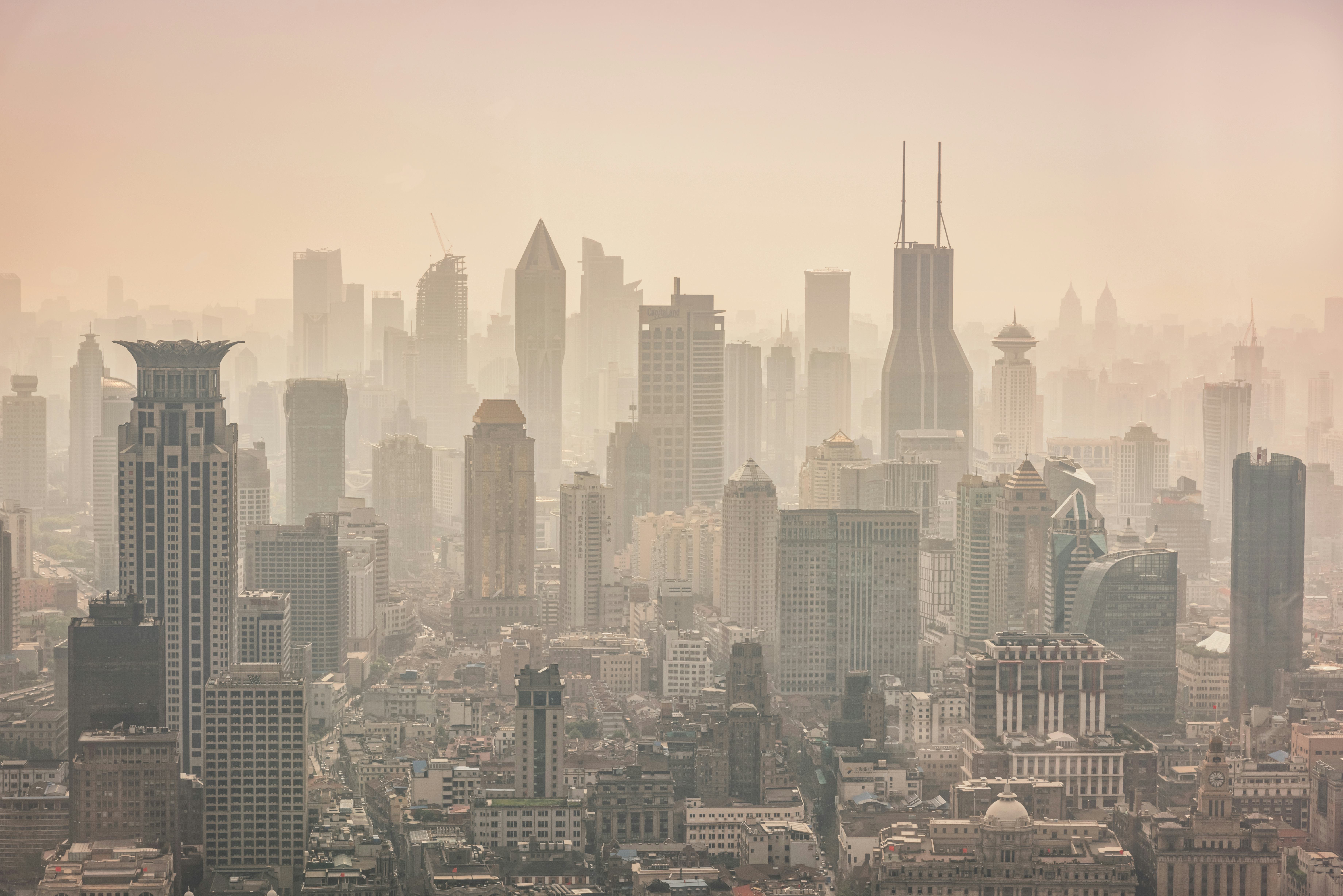 Shanghai foggy modern skyscraper cityscape in early morning light. View from above over the Megacity...