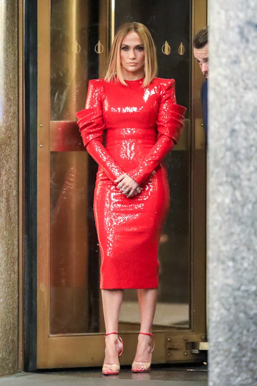 Jennifer Lopez in a form-fitting red dress. 