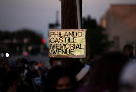 FALCON HEIGHTS, MN - JULY 06: People attend a vigil in honor of Philando Castile, at the site where ...