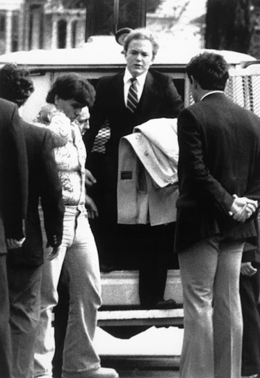 Arne C. Johnson, with coat over arm, steps from a police van on arrival at court in Danbury, CT for ...