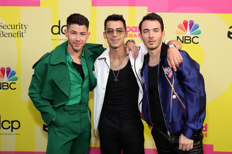Nick Jonas, Joe Jonas, and Kevin Jonas of Jonas Brothers pose backstage at the 2021 Billboard Music ...