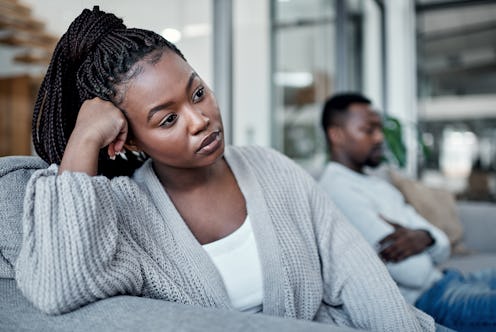 Shot of a young couple ignoring each other after having an argument on the sofa at home