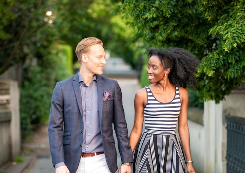 A couple smiling at each other during a walk in Hampstead, London.