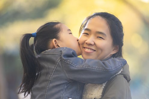 Daughter kissing mom