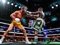 Former world welterweight king Floyd Mayweather (R) and YouTube personality Logan Paul (L) fight in ...