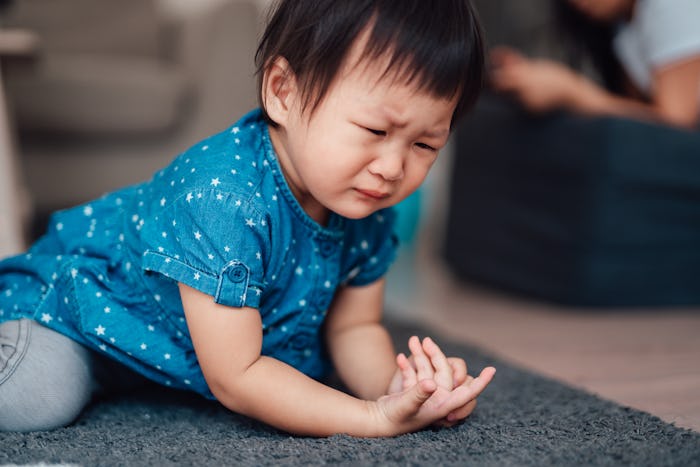 toddler girl crying on floor