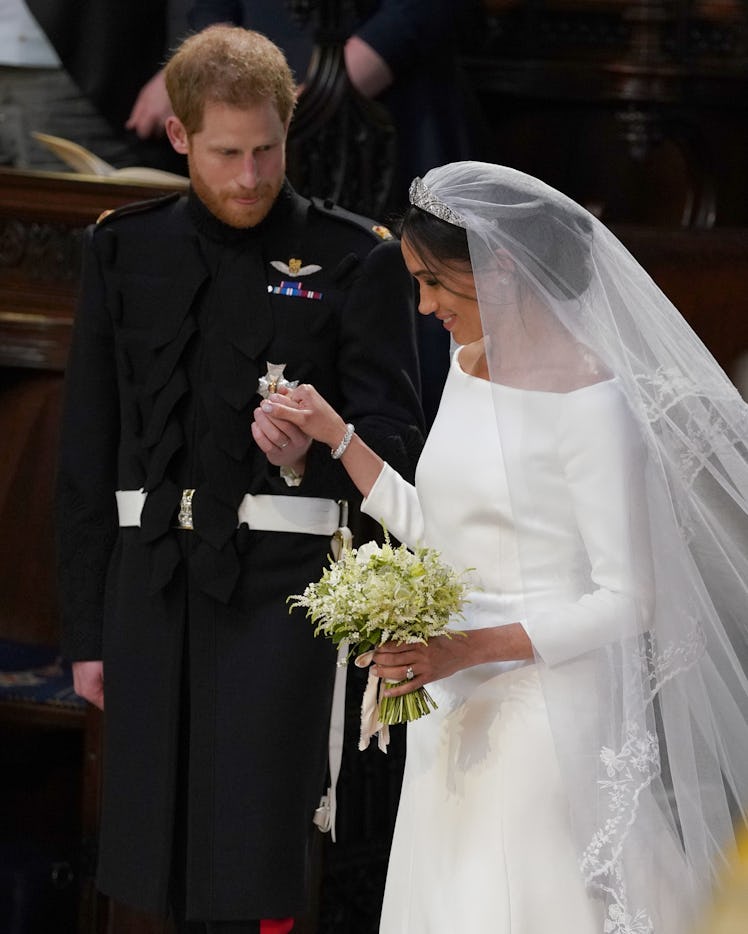 Meghan Markle, Duchess of Sussex, walk back down the aisle away with a bouquet of lillies.