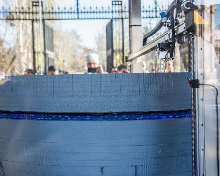 MADRID, SPAIN - 2016/12/18: A 3D large printer making a copy of Star Wars Death Star coinciding with...