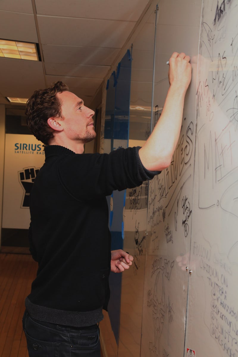 NEW YORK, NY - APRIL 30: Actor Tom Hiddleston draws Loki on the wall at SiriusXM Studio on April 30...