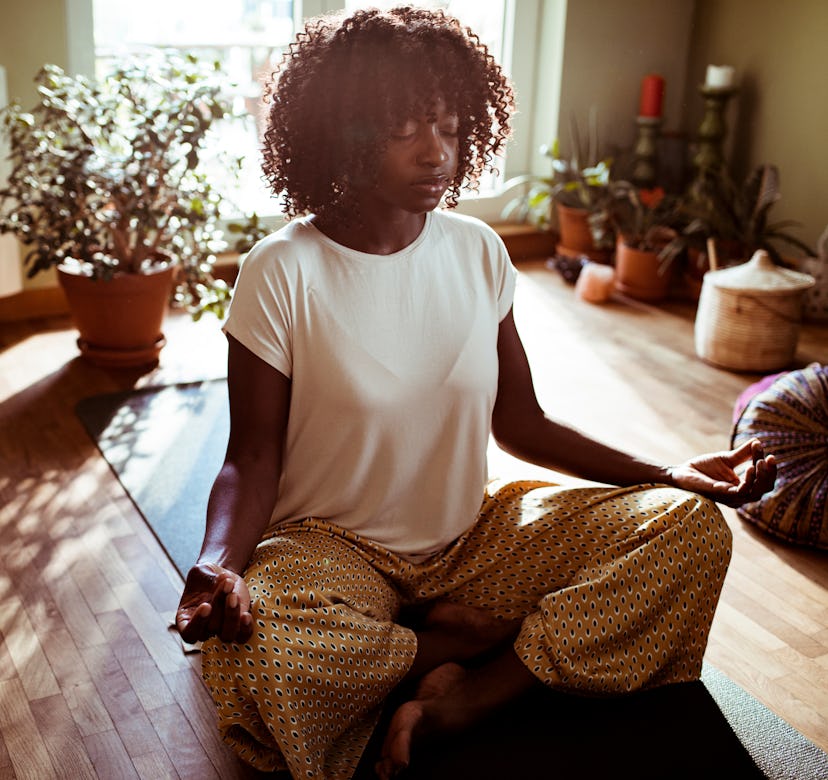 Close up of a young woman doing the Easy Pose at home