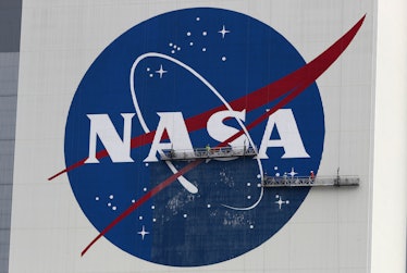 CAPE CANAVERAL, FLORIDA - MAY 28: Workers repaint the NASA logo on the Vehicle Assembly Building at ...